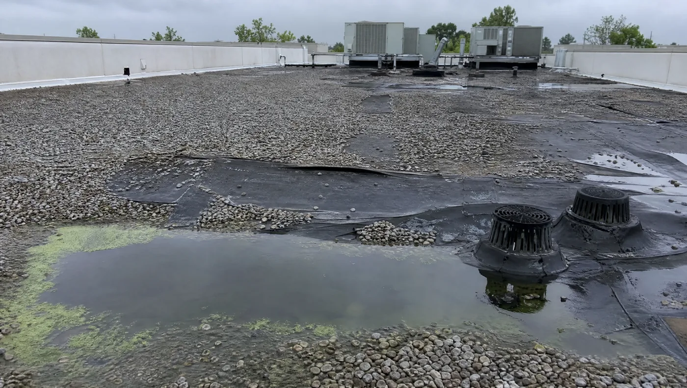 Failing ballasted EPDM roof with ponding water on a Houston distribution building