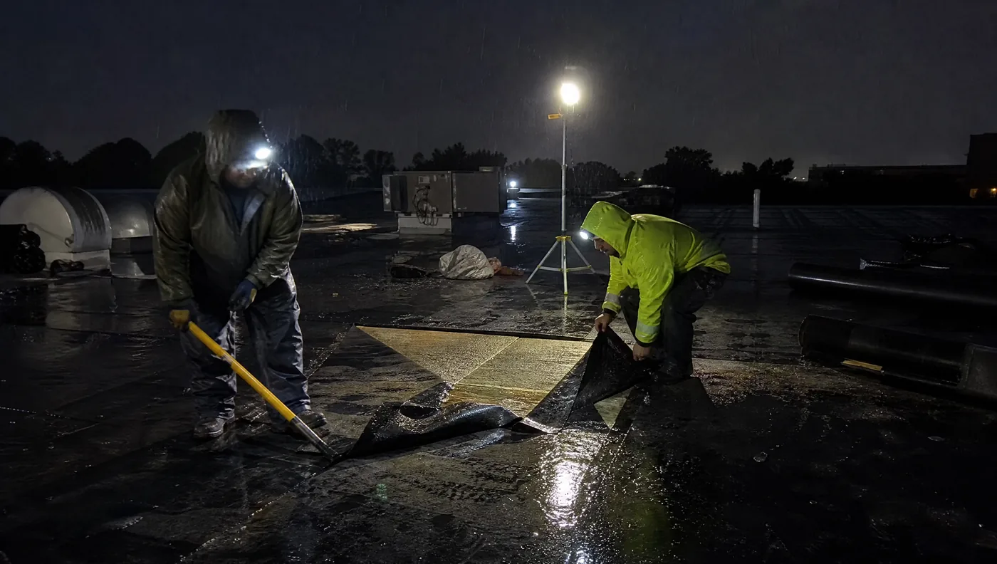 Night emergency tarp and dry-in on a Houston commercial roof after a storm